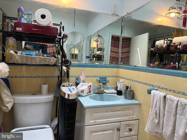 bathroom with tile walls and vanity