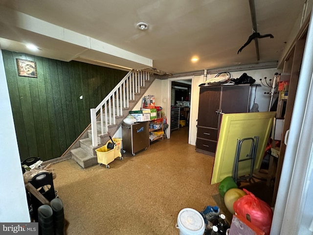 basement featuring wood walls