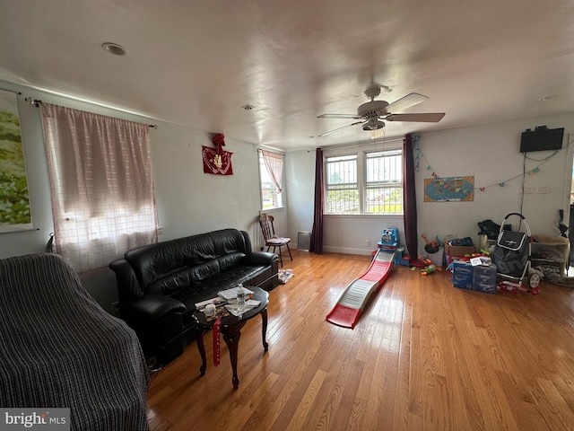 living room featuring ceiling fan and light wood-type flooring