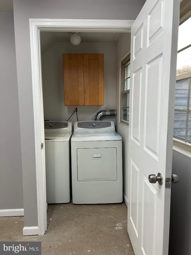 washroom with independent washer and dryer and cabinets