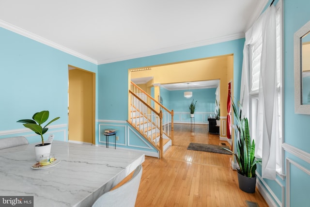 dining area featuring crown molding and hardwood / wood-style floors