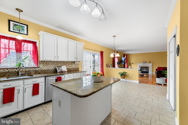 kitchen with sink, dishwasher, white cabinetry, a kitchen island, and decorative light fixtures