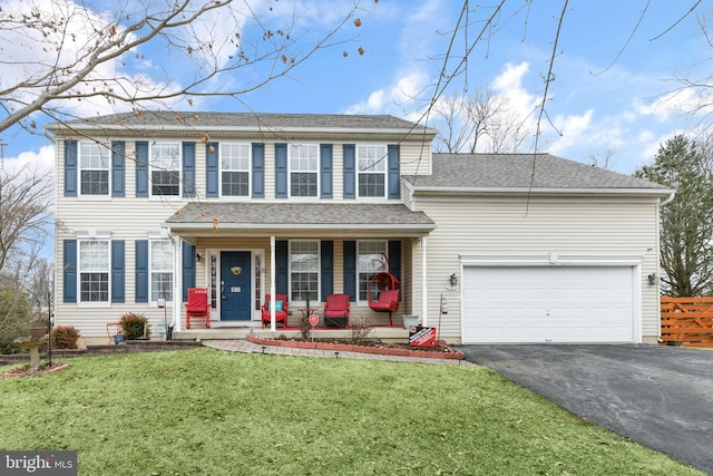 view of front facade with a garage, covered porch, and a front lawn