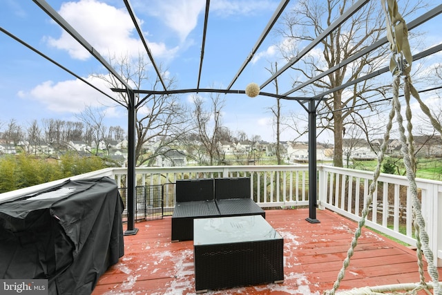 wooden deck featuring a grill