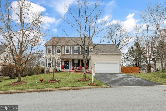 colonial home with a garage, a front lawn, and a porch