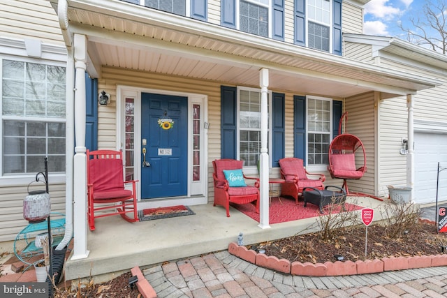 property entrance with a garage and a porch