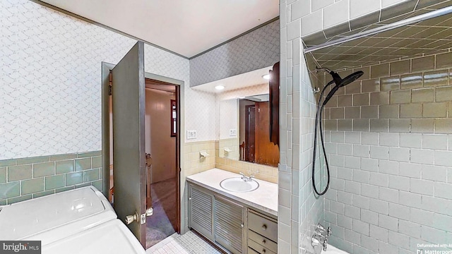 bathroom featuring vanity and tile walls