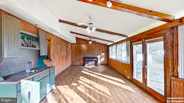 sunroom / solarium featuring sink, vaulted ceiling with beams, and ceiling fan