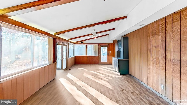 unfurnished sunroom featuring vaulted ceiling with beams and ceiling fan