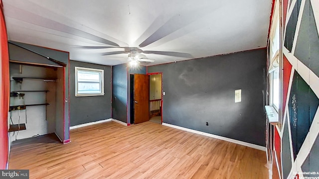 unfurnished bedroom with ceiling fan and light hardwood / wood-style floors