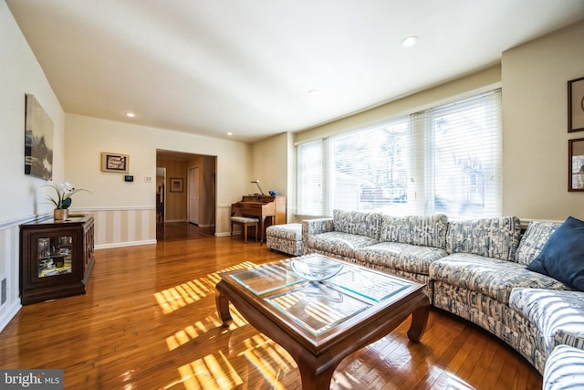 living room featuring wood-type flooring and recessed lighting