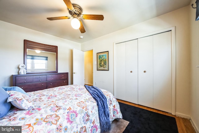 bedroom with a ceiling fan, a closet, and wood finished floors