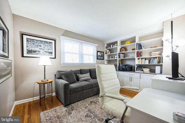 office area featuring light wood-style flooring and baseboards