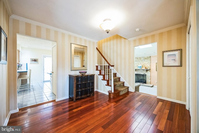 foyer with stairway, dark wood finished floors, and wallpapered walls