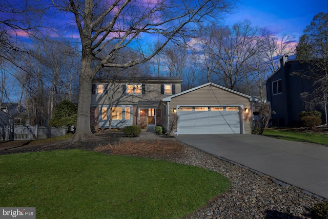 view of front of property featuring driveway, a lawn, an attached garage, and fence