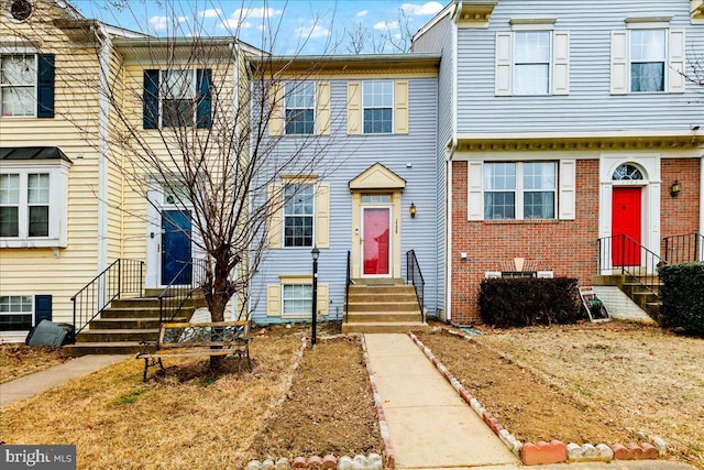 view of property featuring brick siding and entry steps