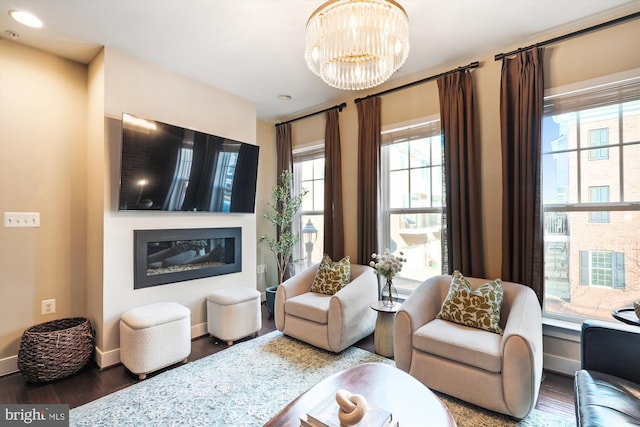 living room with dark hardwood / wood-style flooring and a notable chandelier