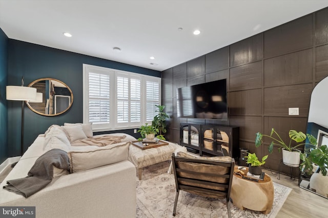 living room with light wood-style floors and recessed lighting