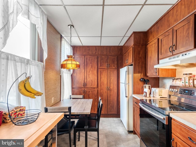 kitchen with white refrigerator, stainless steel electric range oven, a paneled ceiling, and pendant lighting