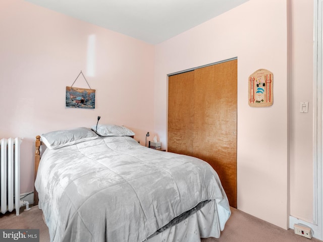 bedroom featuring radiator heating unit and light carpet