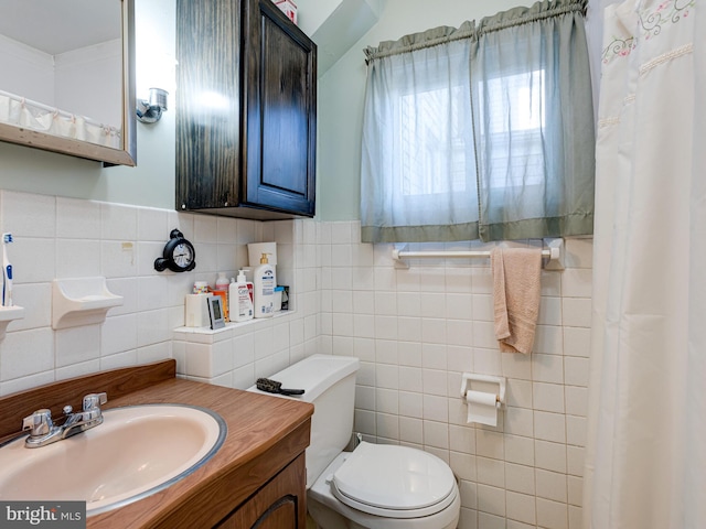 bathroom with vanity, toilet, and tile walls