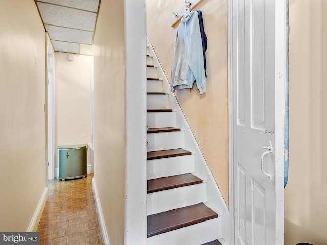 stairs featuring parquet floors