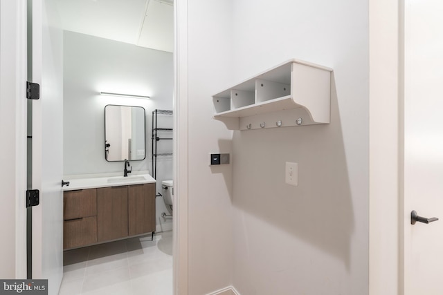 bathroom featuring vanity, tile patterned floors, and toilet