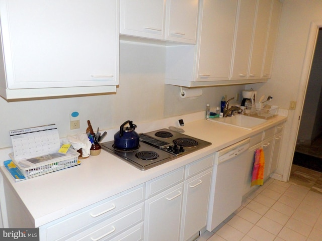 kitchen with dishwasher, light countertops, stainless steel electric cooktop, white cabinetry, and a sink