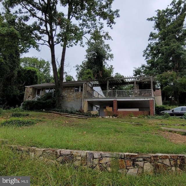 view of front of home featuring stone siding and a pergola