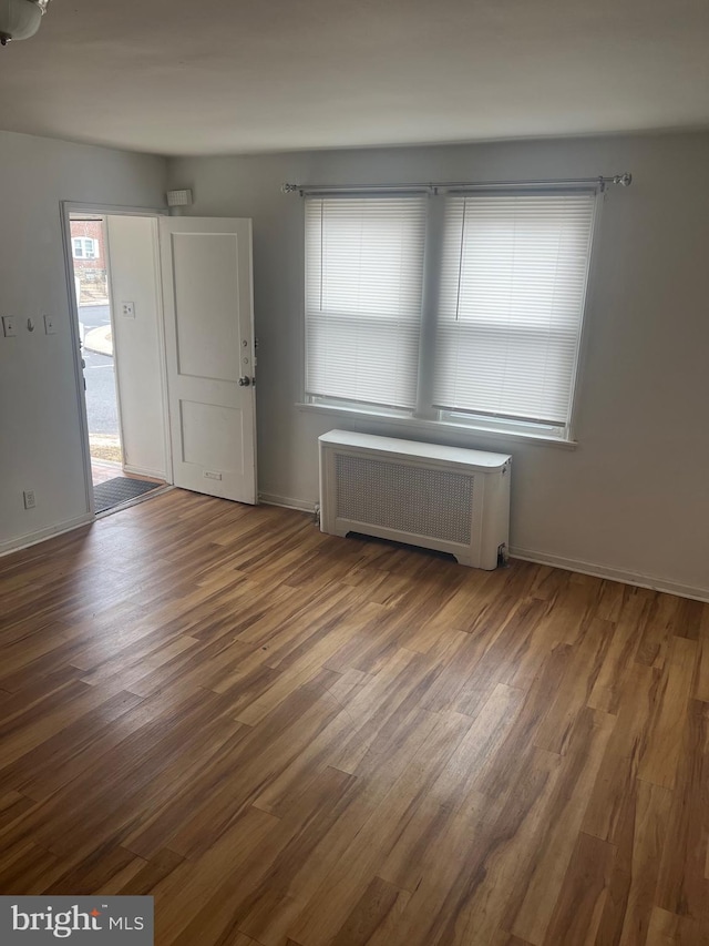 interior space featuring dark hardwood / wood-style floors and radiator heating unit