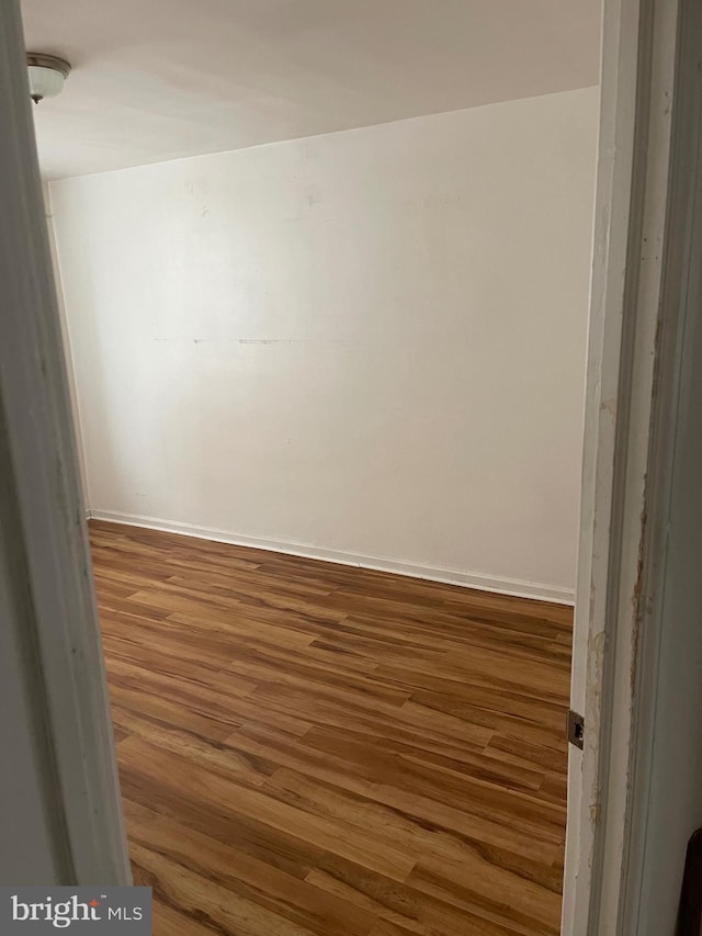 unfurnished room featuring wood-type flooring