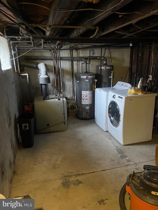 basement featuring water heater and washing machine and clothes dryer