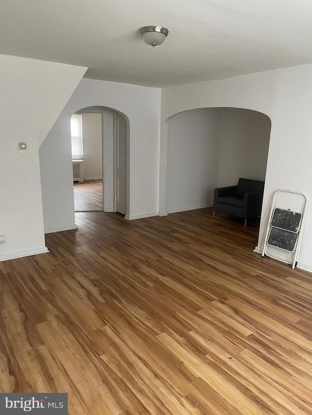 bonus room featuring hardwood / wood-style flooring and heating unit