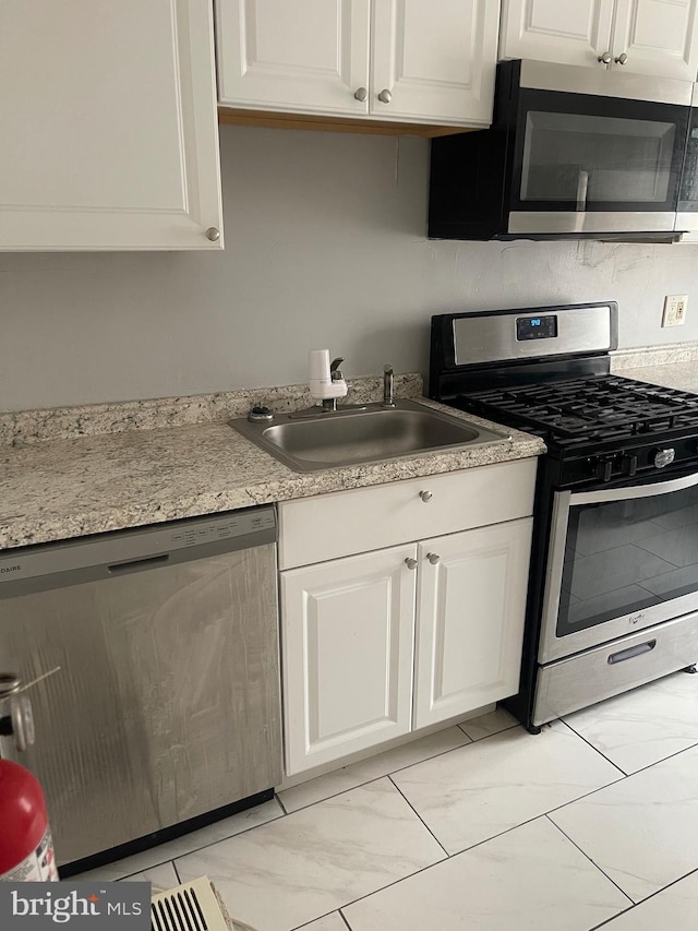 kitchen featuring white cabinetry, appliances with stainless steel finishes, and sink