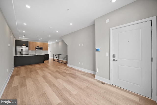 unfurnished living room featuring light hardwood / wood-style floors