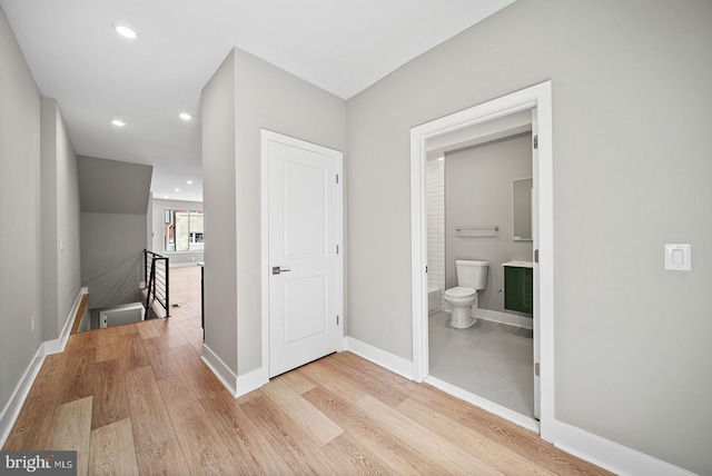 corridor with light hardwood / wood-style floors