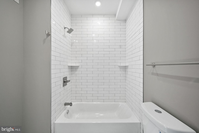 bathroom featuring toilet and tiled shower / bath combo