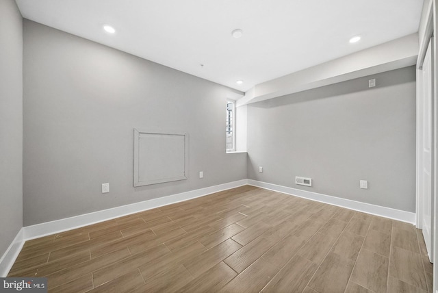 spare room with wood-type flooring