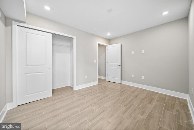 unfurnished bedroom featuring a closet and light wood-type flooring