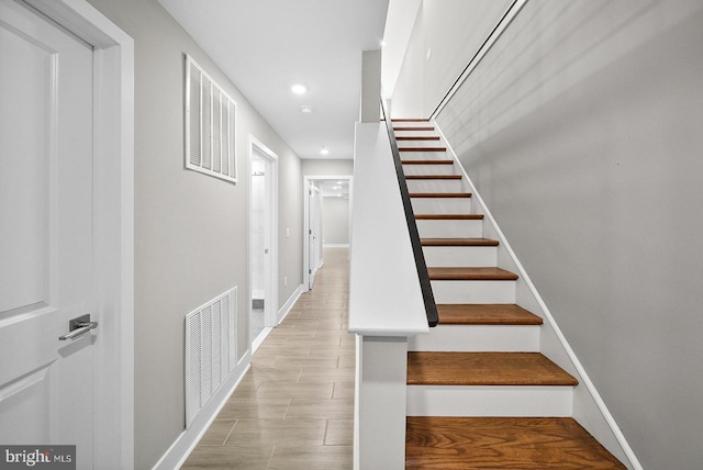 staircase featuring hardwood / wood-style floors