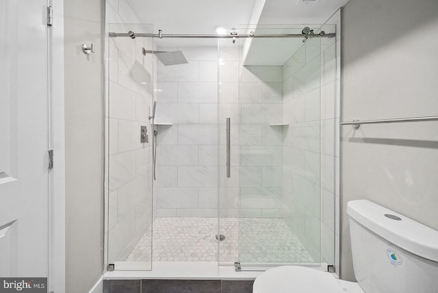 bathroom with an enclosed shower and toilet