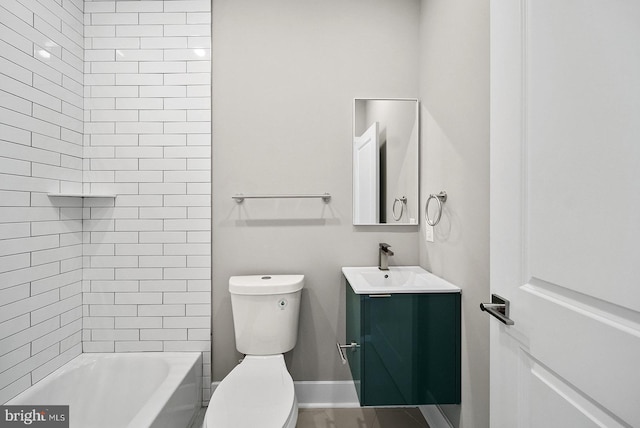 full bathroom with vanity, tiled shower / bath combo, and toilet