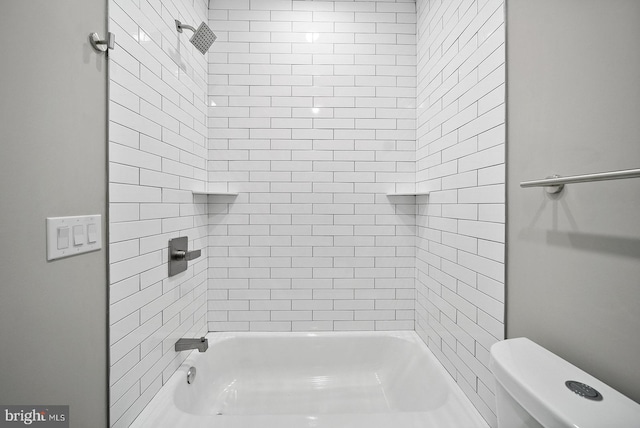 bathroom with toilet and tiled shower / bath combo