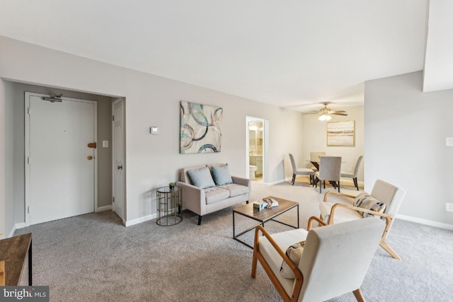 carpeted living room with ceiling fan