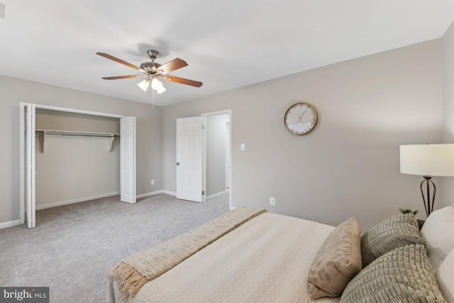 bedroom with light carpet, ceiling fan, and a closet