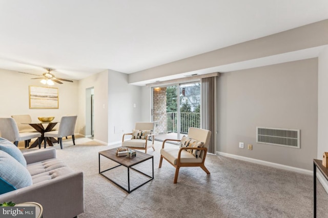 living room with light carpet and ceiling fan