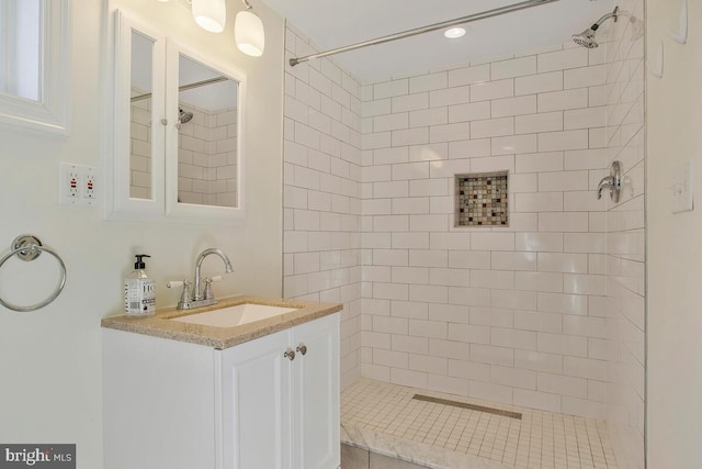 bathroom featuring vanity and tiled shower