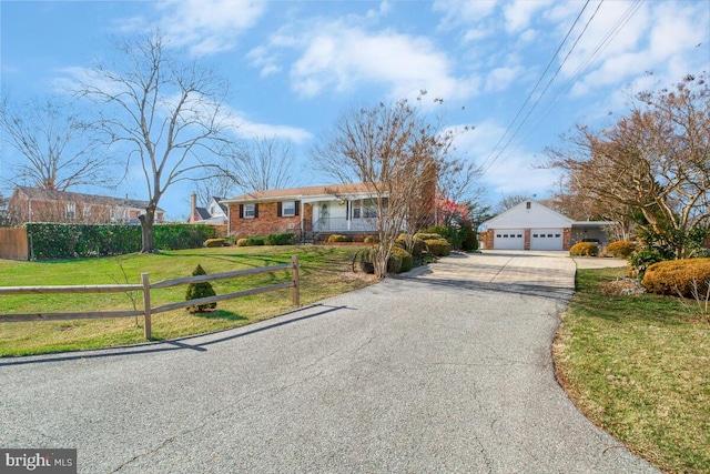 ranch-style home featuring a garage and a front yard