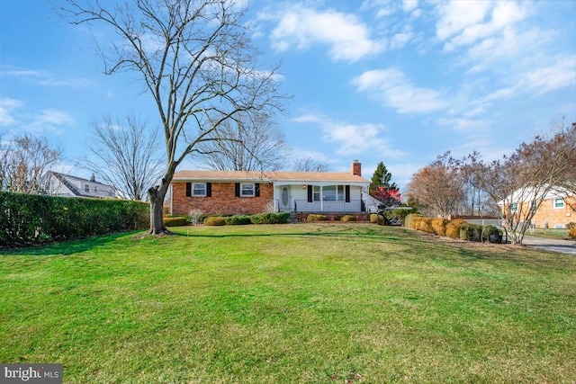 ranch-style house with a porch and a front yard