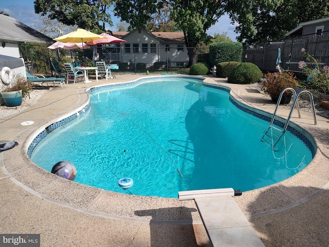 view of pool featuring a patio